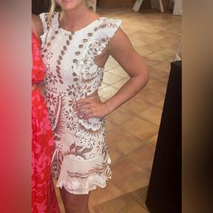 White mini dress with sequin details and open back.